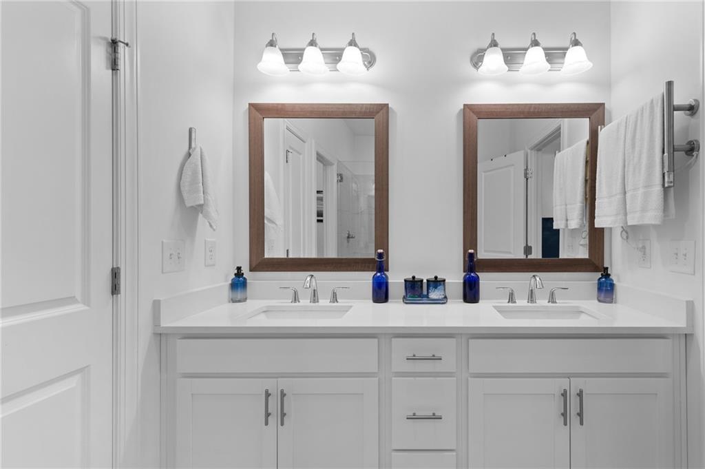 300 Olmstead Way Alpharetta, GA 30022 - Photo 34 of 52 a bathroom with double vanity sinks and a mirror