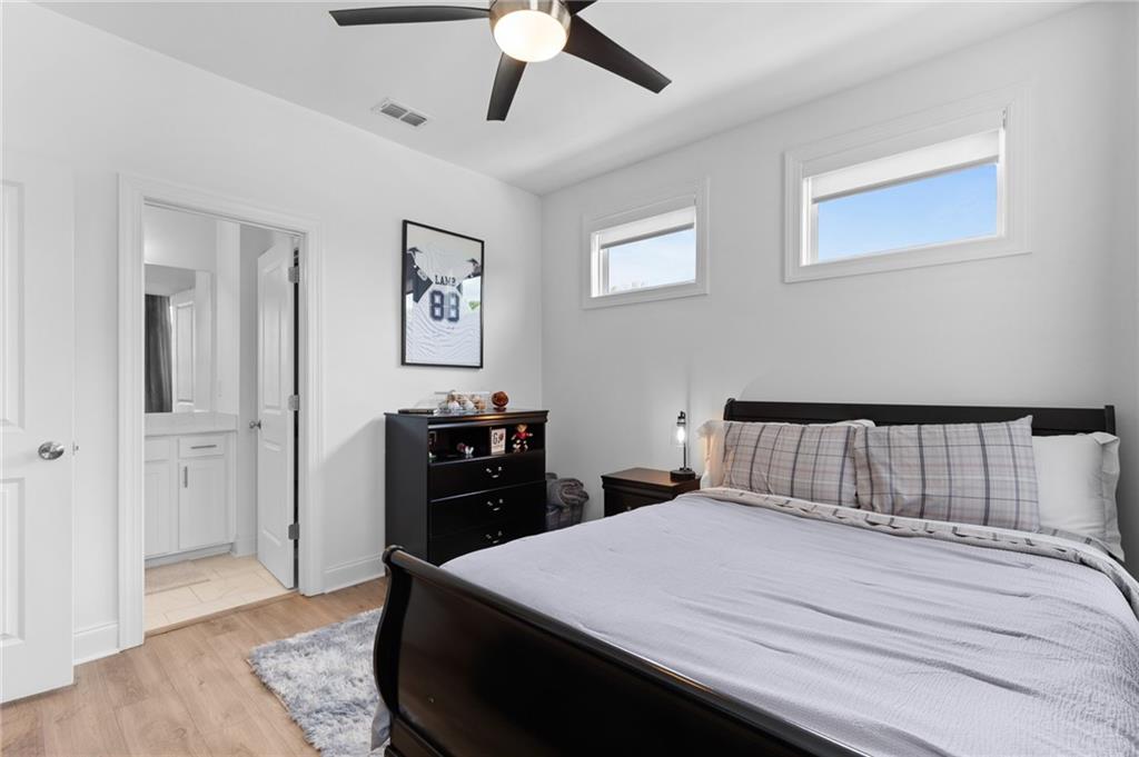 300 Olmstead Way Alpharetta, GA 30022 - Photo 38 of 52 a bedroom with a bed and wooden floor