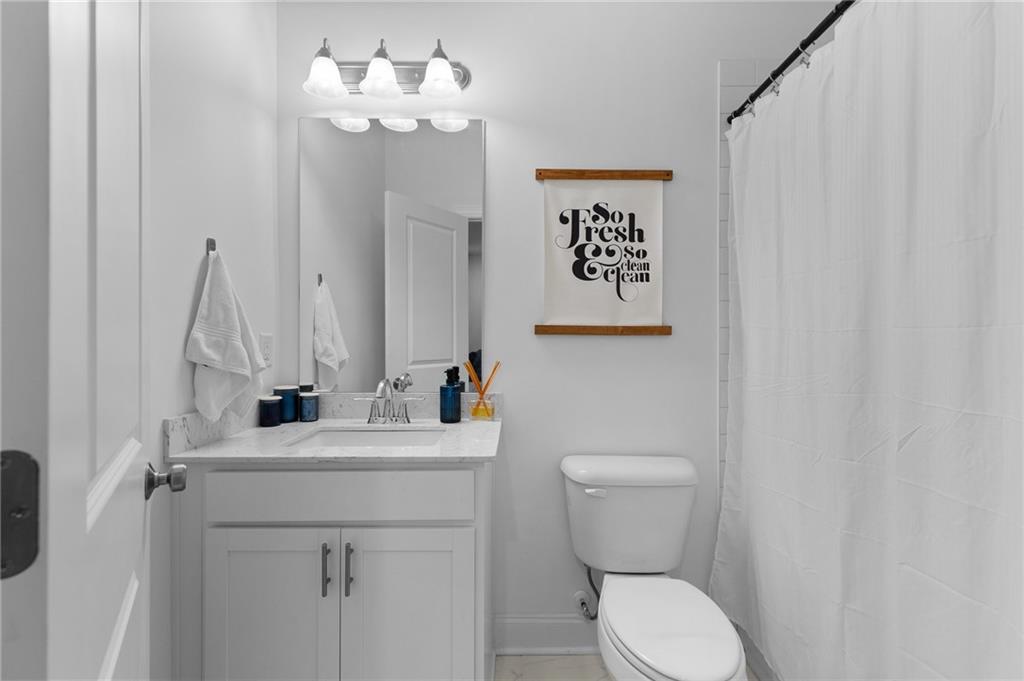 300 Olmstead Way Alpharetta, GA 30022 - Photo 45 of 52 a bathroom with a toilet sink and mirror