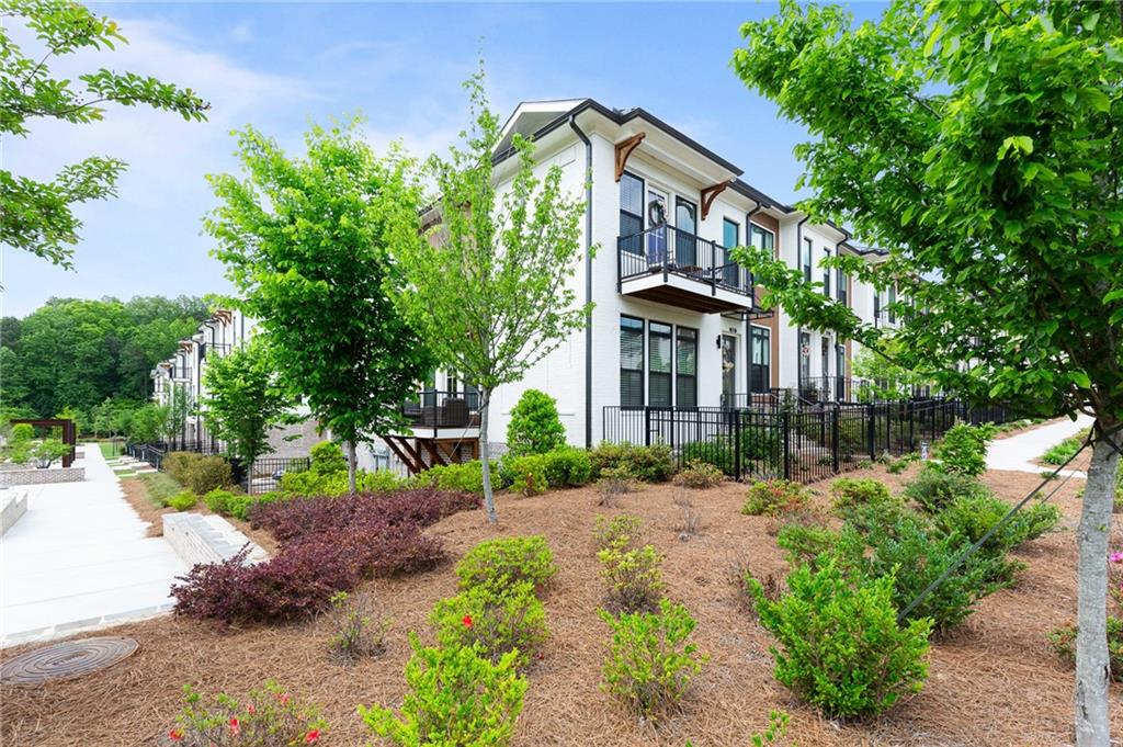 300 Olmstead Way Alpharetta, GA 30022 - Photo 49 of 52 a front view of a house with a yard and fountain in middle