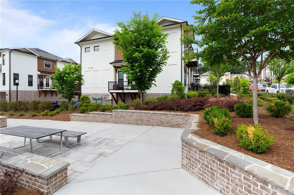 300 Olmstead Way Alpharetta, GA 30022 - Photo 50 of 52 a view of a patio with couches and table and chairs and potted plants