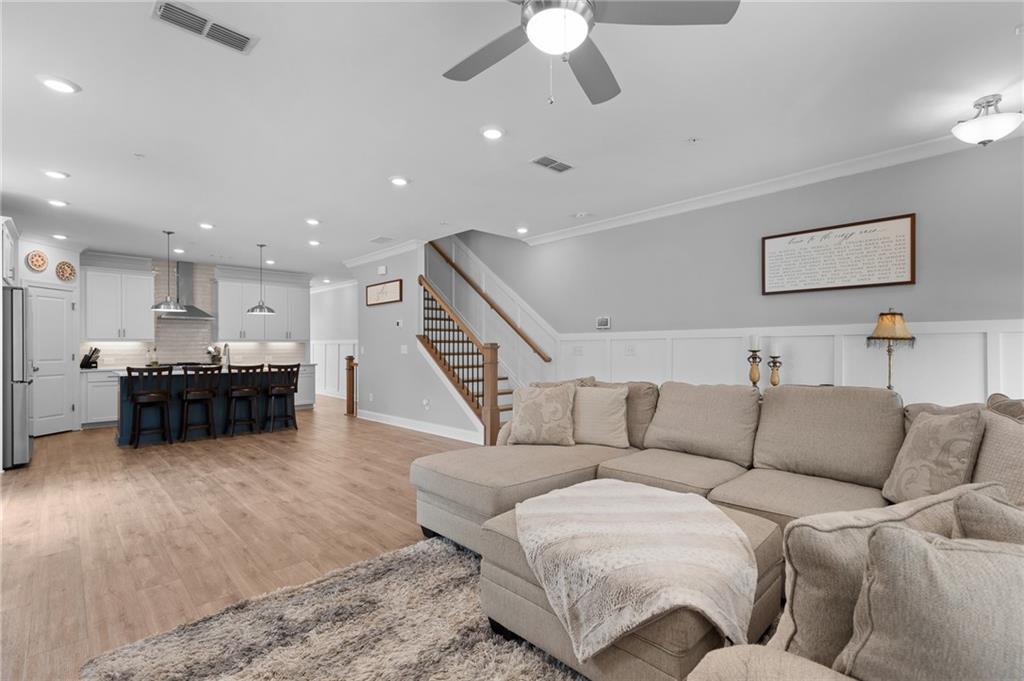 300 Olmstead Way Alpharetta, GA 30022 - Photo 6 of 52 a living room with furniture and a ceiling fan