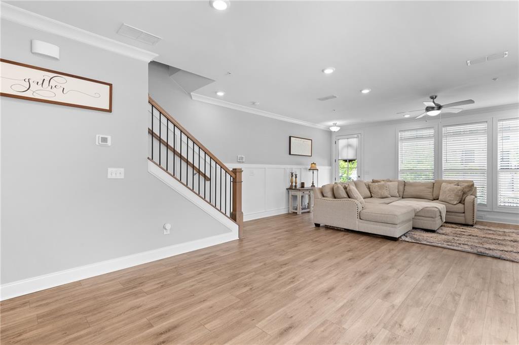 300 Olmstead Way Alpharetta, GA 30022 - Photo 10 of 52 a living room with furniture and a wooden floor