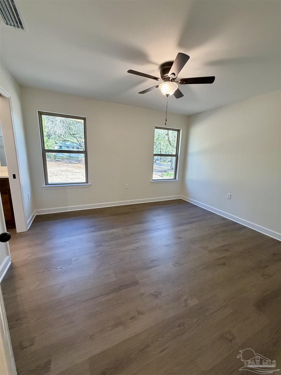 6288 Long Street Milton, FL 32570 - Photo 13 of 16 a view of an empty room with a window and wooden floor