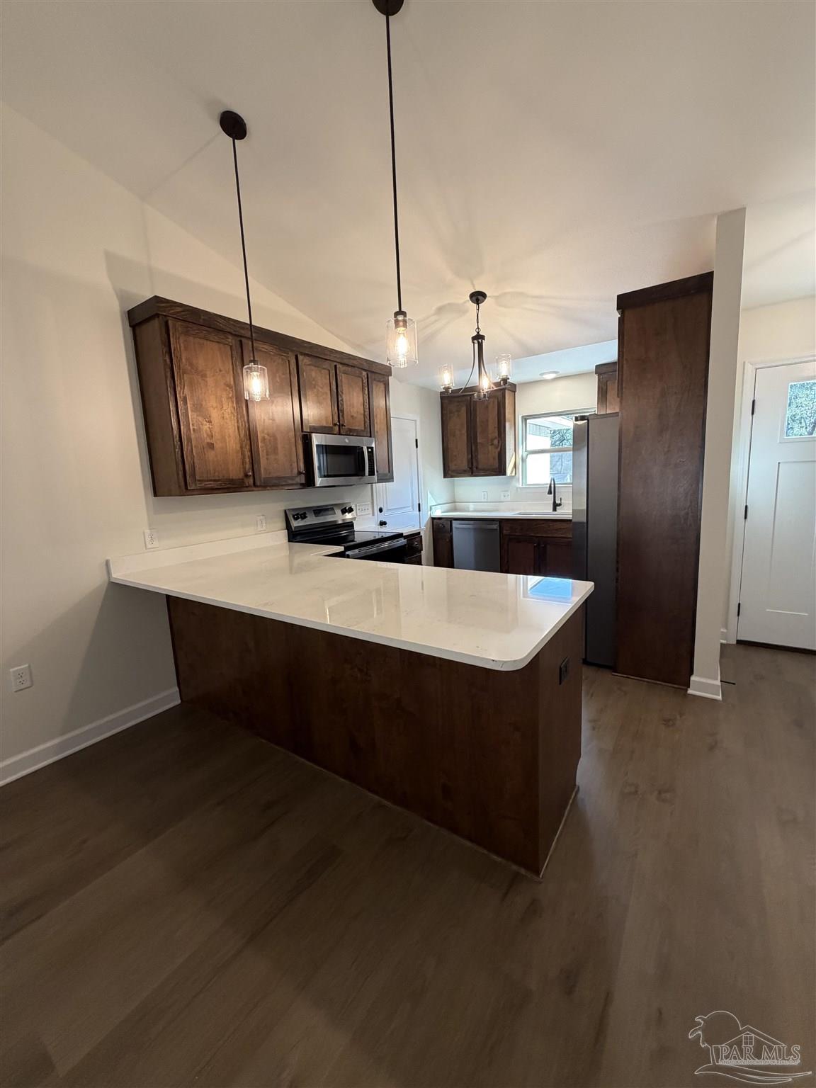 6288 Long Street Milton, FL 32570 - Photo 4 of 16 a kitchen with stainless steel appliances granite countertop a sink a stove and a refrigerator