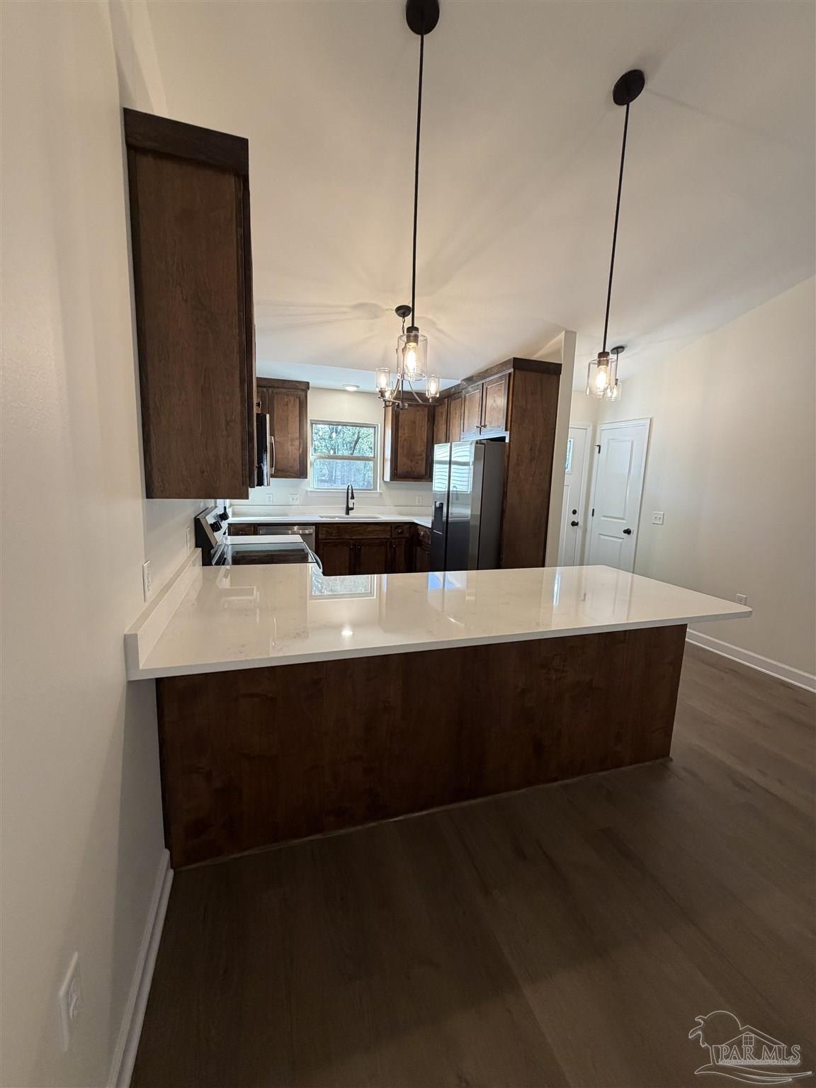 6288 Long Street Milton, FL 32570 - Photo 8 of 16 a view of a living room with kitchen island furniture and wooden floor
