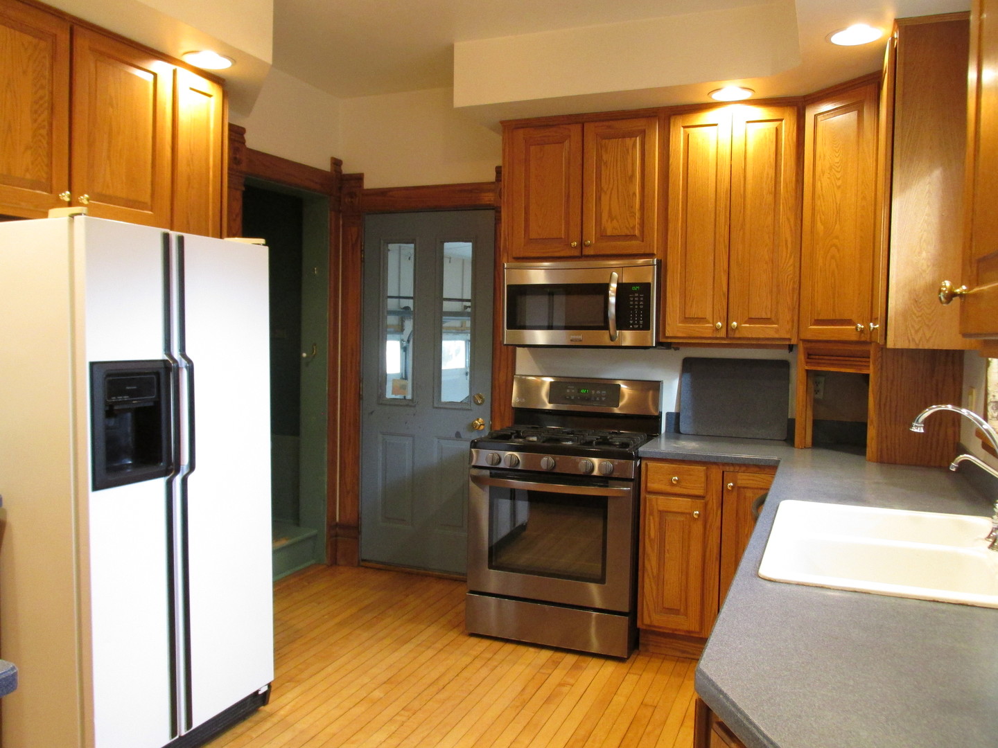 603 North 8th Street Rochelle, IL 61068 - Photo 9 of 33 a kitchen with stainless steel appliances granite countertop a stove a refrigerator and a microwave