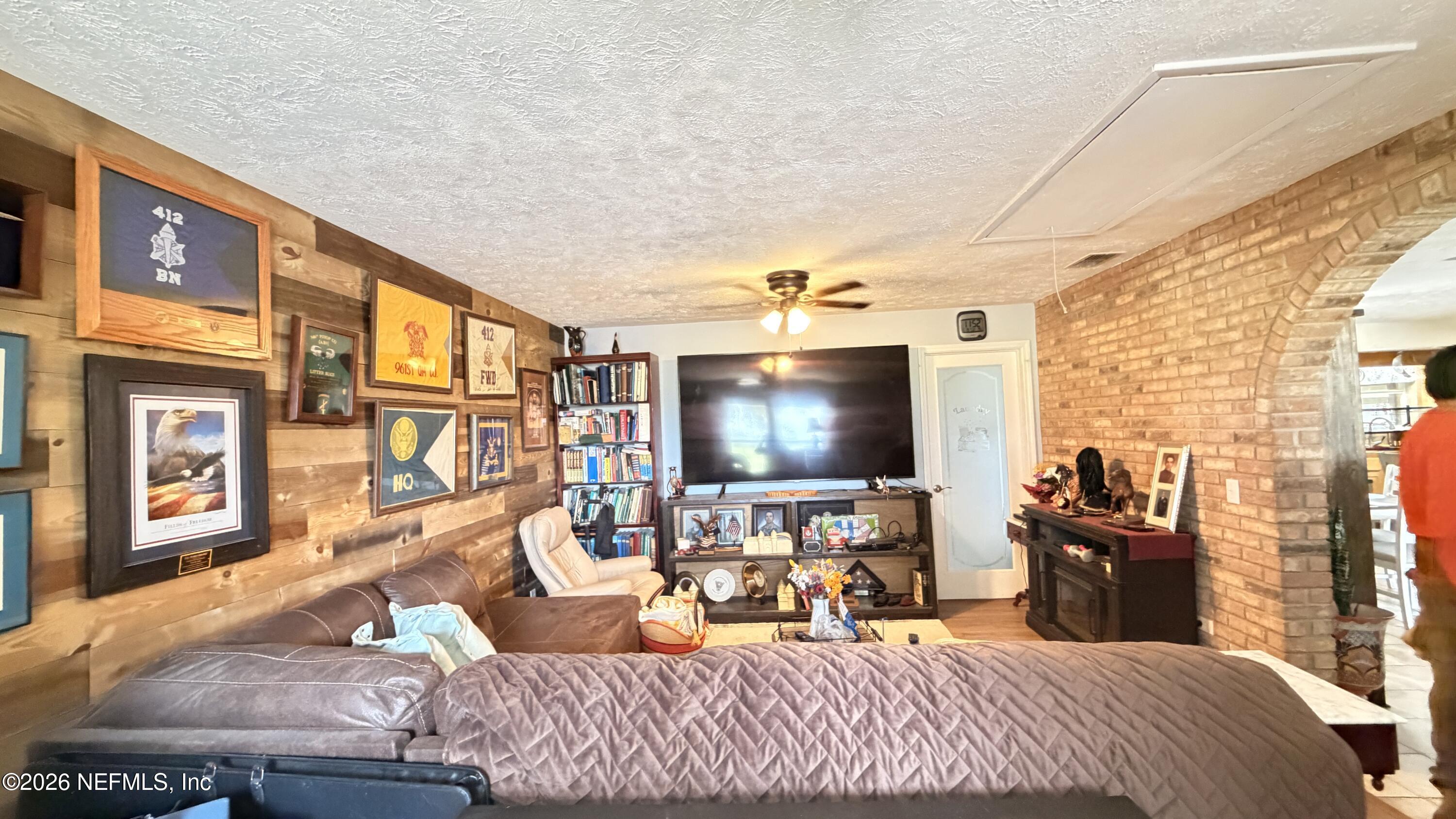 1302 Fort Meade Road Frostproof, FL 33843 - Photo 25 of 39 a bedroom with furniture and a flat screen tv
