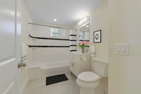 a bathroom with a toilet sink and shower