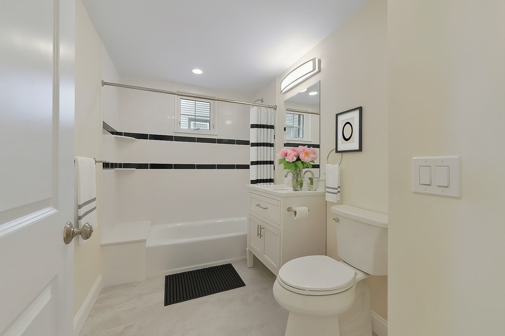 48 Manthorne Road, Unit 1 Boston, MA 02132 - Photo 13 of 17 a bathroom with a toilet sink and shower