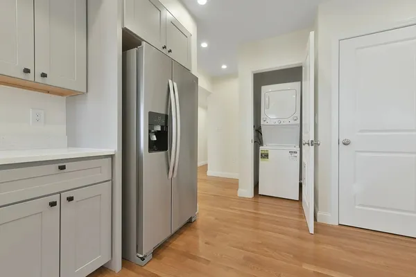 a view of a hallway with wooden floor