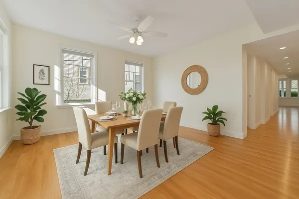 a view of a dining room with furniture and wooden floor