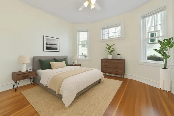 a bedroom with a bed and a potted plant