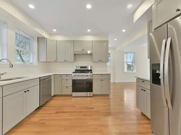 a kitchen with stainless steel appliances granite countertop a refrigerator sink and stove
