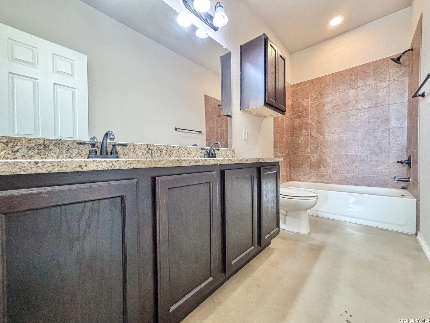 746-748 Saengerhalle Road New Braunfels, TX 78130 - Photo 13 of 14 a spacious bathroom with a granite countertop sink a toilet mirror and bathtub