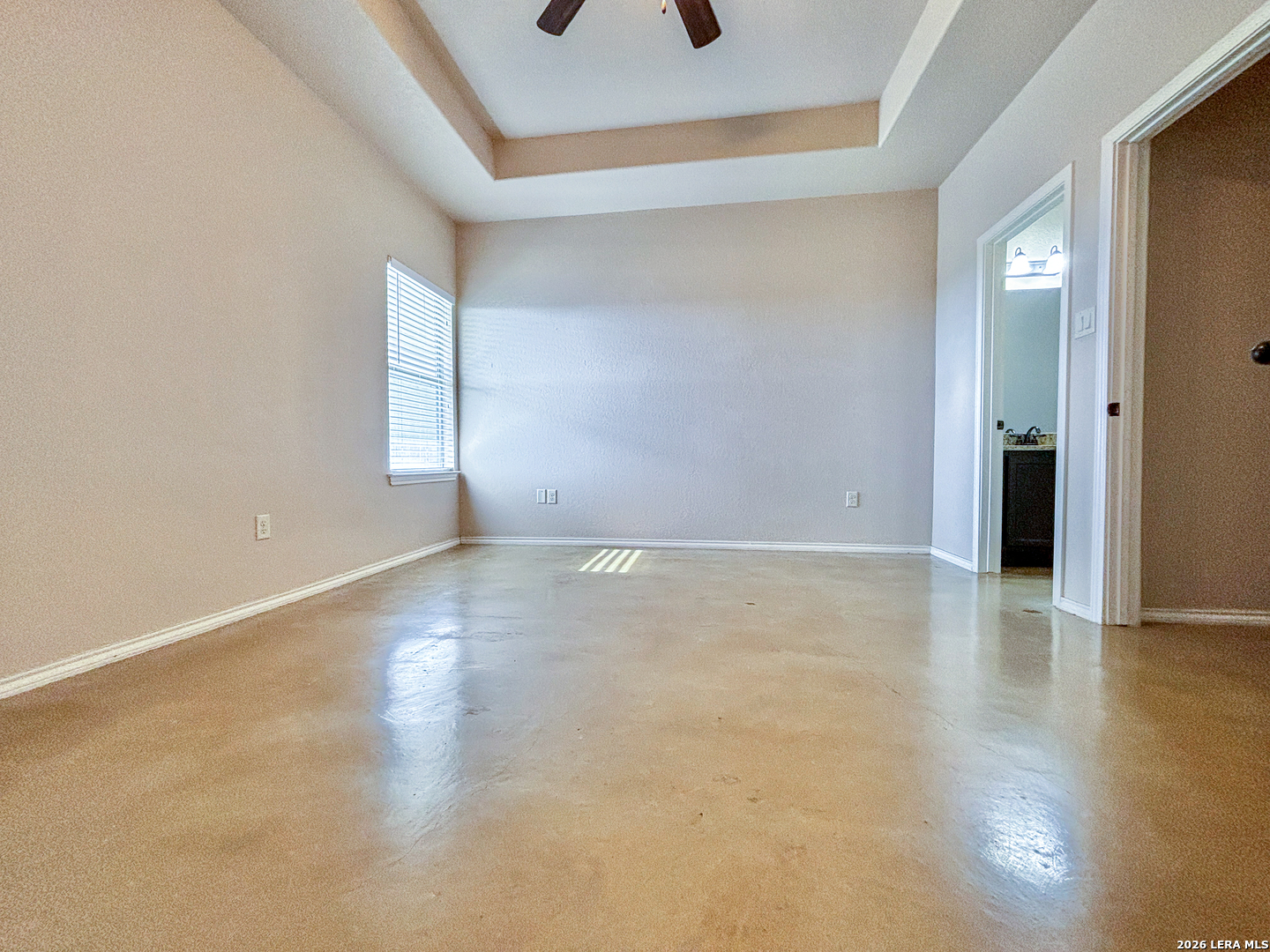 746-748 Saengerhalle Road New Braunfels, TX 78130 - Photo 3 of 14 an empty room with wooden floor and windows with curtains