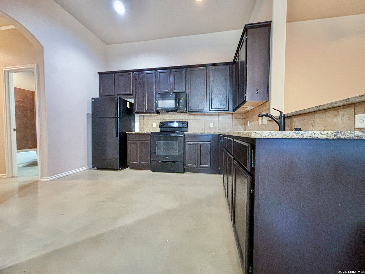 746-748 Saengerhalle Road New Braunfels, TX 78130 - Photo 7 of 14 a kitchen with stainless steel appliances granite countertop a refrigerator sink and cabinets