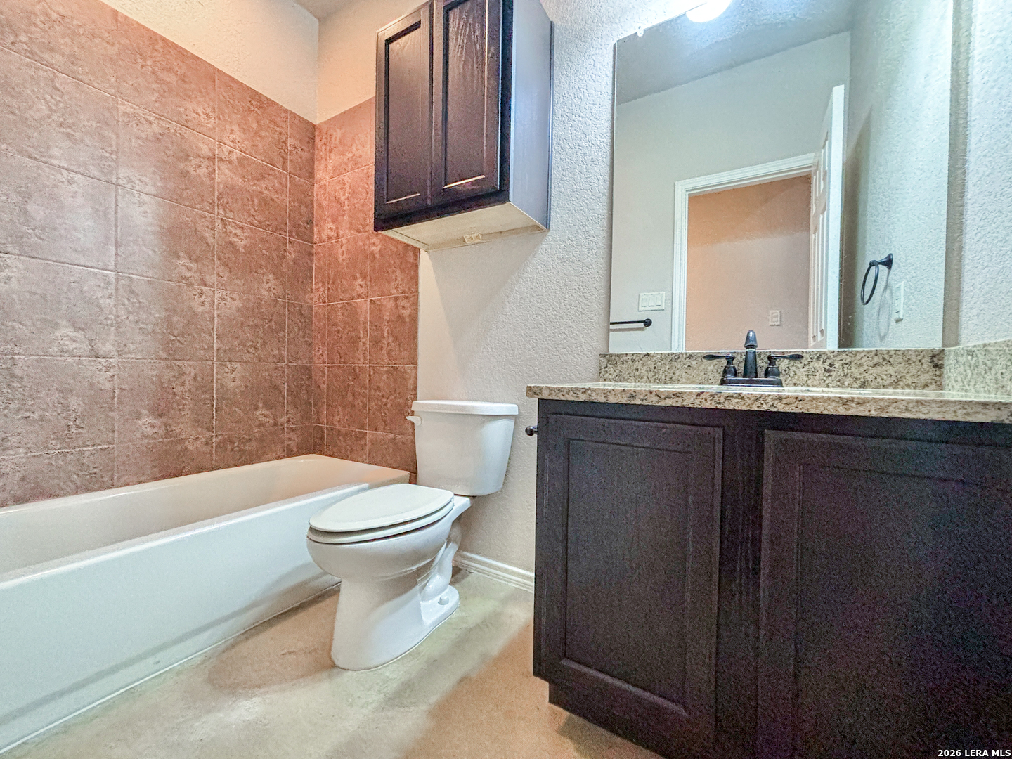 746-748 Saengerhalle Road New Braunfels, TX 78130 - Photo 10 of 14 a bathroom with a granite countertop toilet sink and mirror