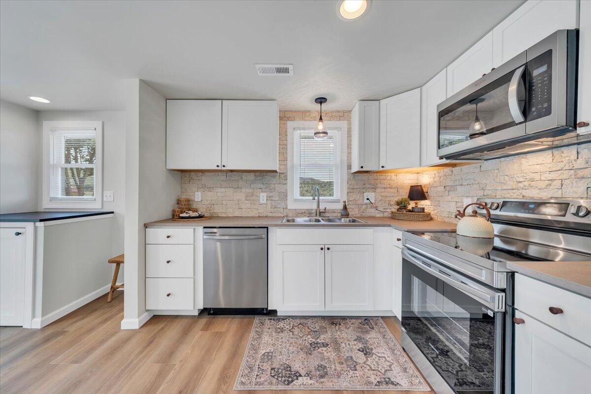 7153 Peppers Ferry Road Max Meadows, VA 24360 - Photo 14 of 67 a kitchen with stainless steel appliances granite countertop a stove a sink and a microwave