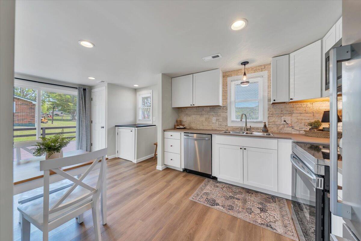 7153 Peppers Ferry Road Max Meadows, VA 24360 - Photo 16 of 67 a kitchen with granite countertop white cabinets and white appliances