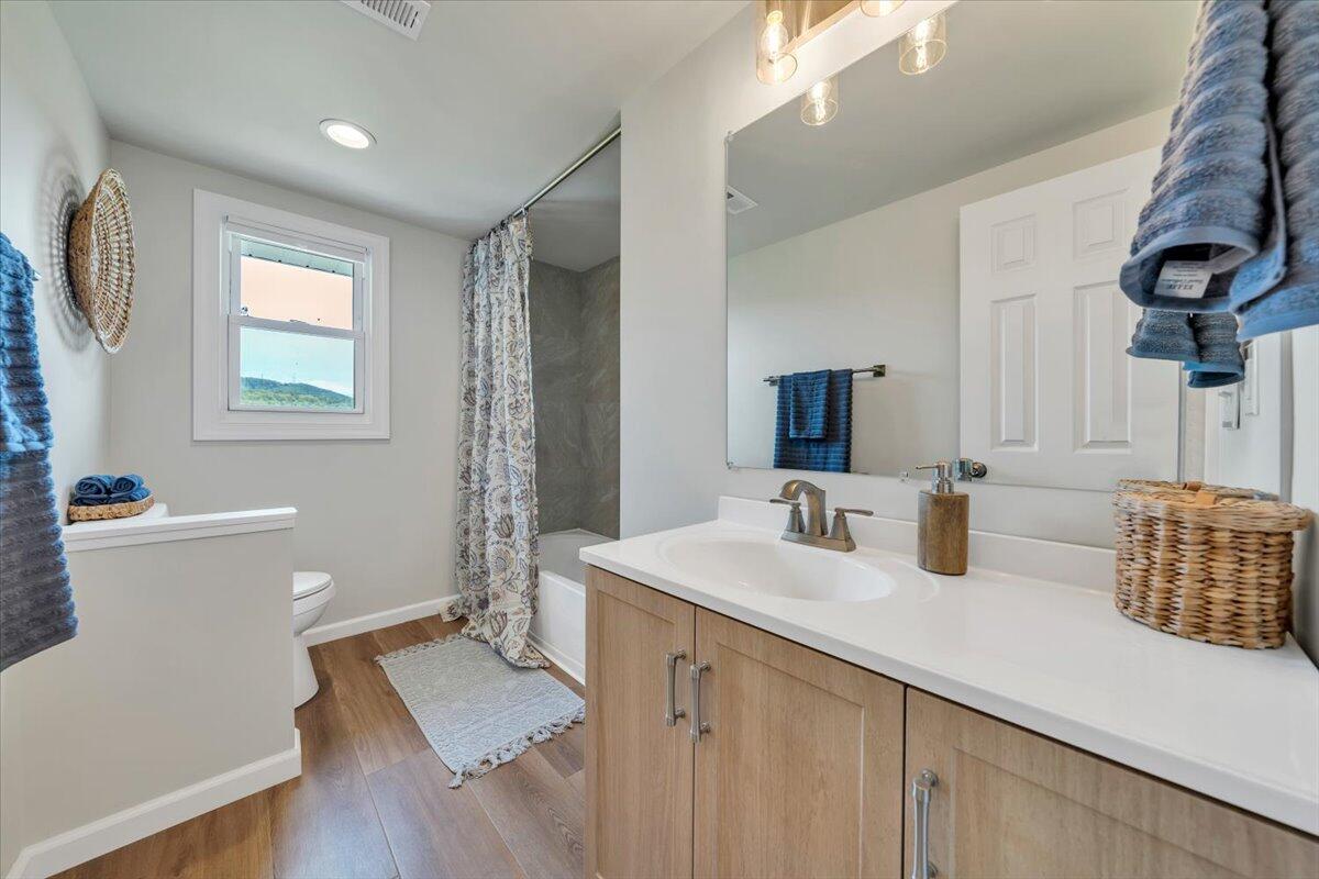 7153 Peppers Ferry Road Max Meadows, VA 24360 - Photo 20 of 67 a bathroom with a double vanity sink a mirror and a bathtub
