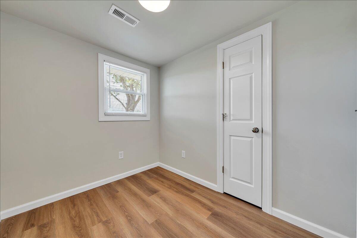 7153 Peppers Ferry Road Max Meadows, VA 24360 - Photo 24 of 67 an empty room with wooden floor and windows