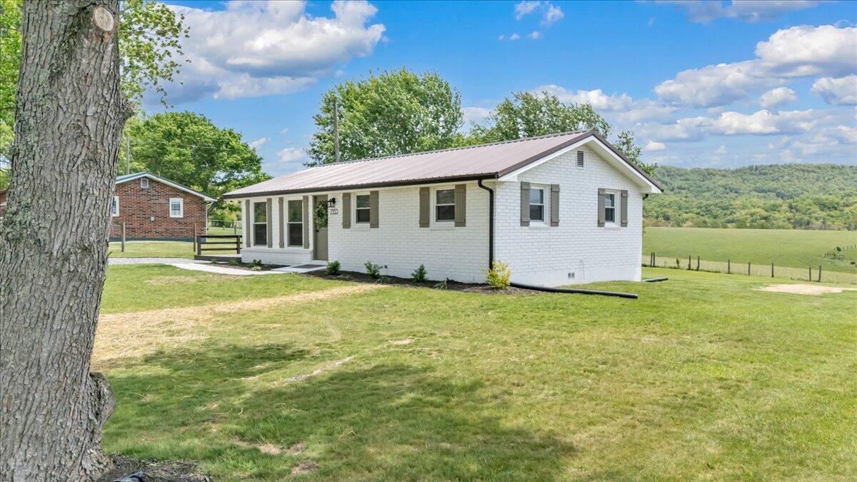 7153 Peppers Ferry Road Max Meadows, VA 24360 - Photo 57 of 67 a front view of house with yard and trees in the background