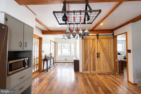 a view of a livingroom with wooden floor and a ceiling fan