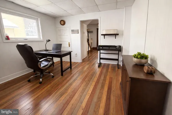 a view of a workspace with furniture and a window