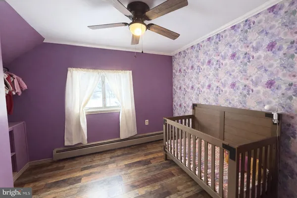 a bedroom with a bed and a chandelier fan