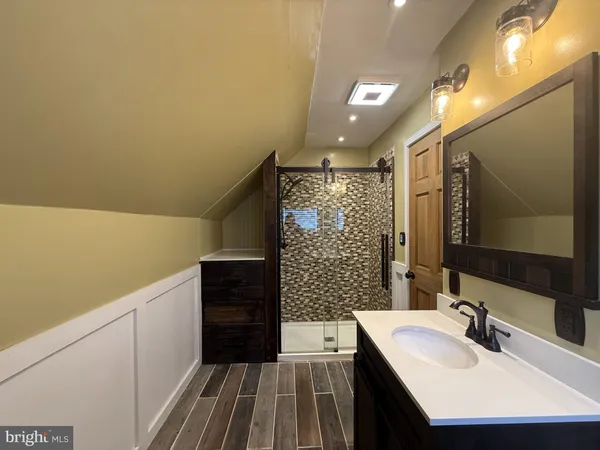 a bathroom with a sink a vanity and a mirror