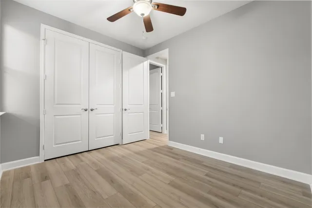 an empty room with closet and windows