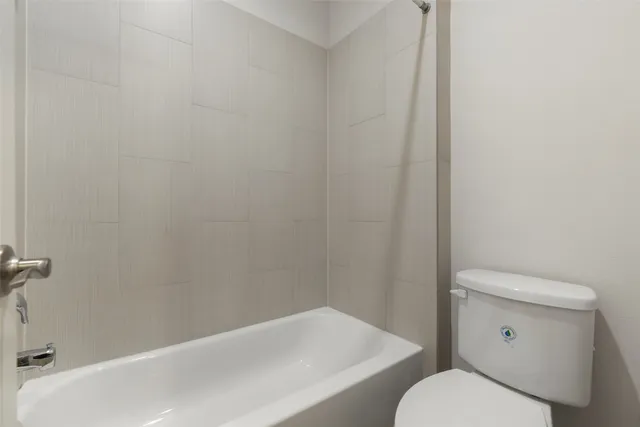 a bathroom with a toilet and a bathtub