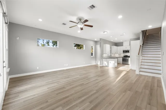 a view of a kitchen with wooden floor and a kitchen