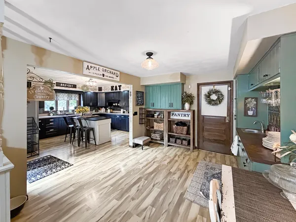 a living room with lots of furniture a wooden floor and furniture