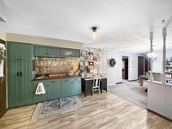 a room with kitchen island granite countertop furniture and a wooden floor