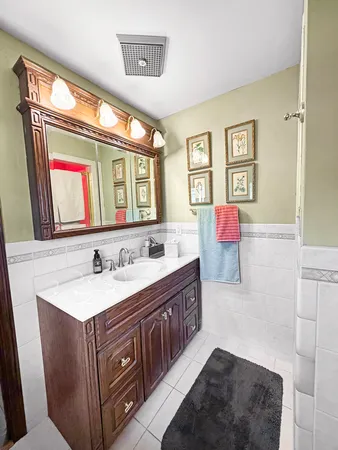 a bathroom with a sink a vanity and a mirror