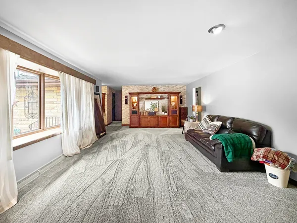 a spacious bedroom with a bed and large windows