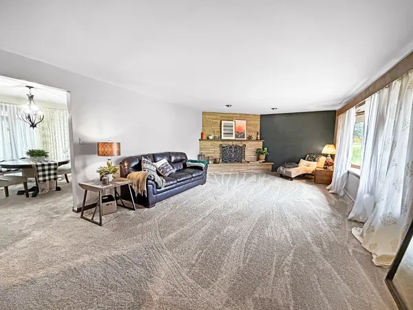 a bed room with furniture and a large window