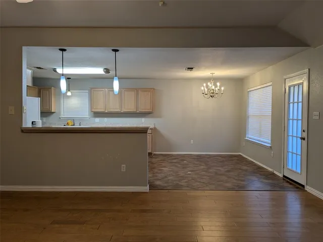 a view of a kitchen with a dishwasher and wooden floor