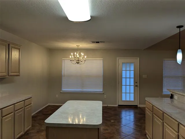 a stove top oven sitting inside of a kitchen