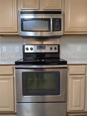 a kitchen with a sink and chandelier