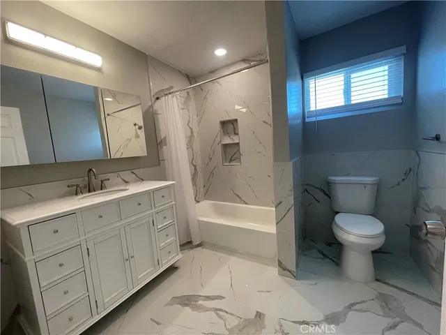 a bathroom with a toilet sink and bathtub