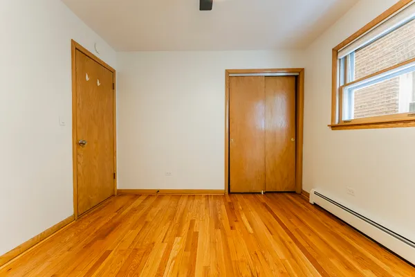 a view of a room with wooden floor and door