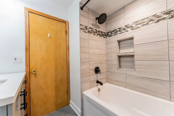 a bathroom with a tub and a shower
