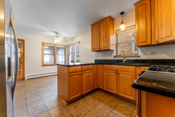 a kitchen with stainless steel appliances granite countertop a stove a sink and a microwave