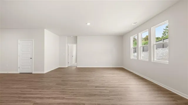 wooden floor in an empty room and a bathroom