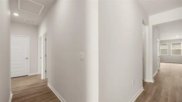 a view of a hallway with wooden floor