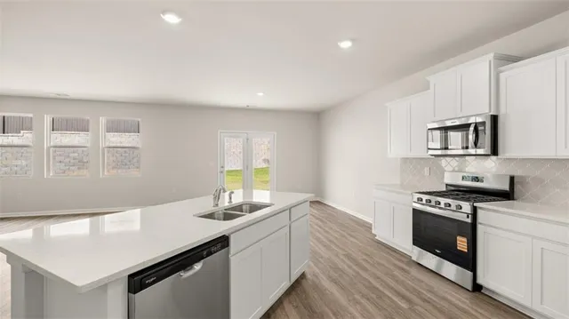 a kitchen with a stove and a microwave