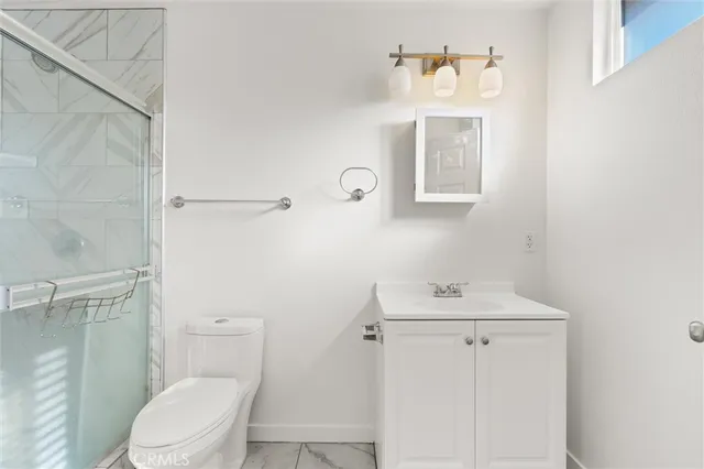 a bathroom with a sink mirror toilet and vanity